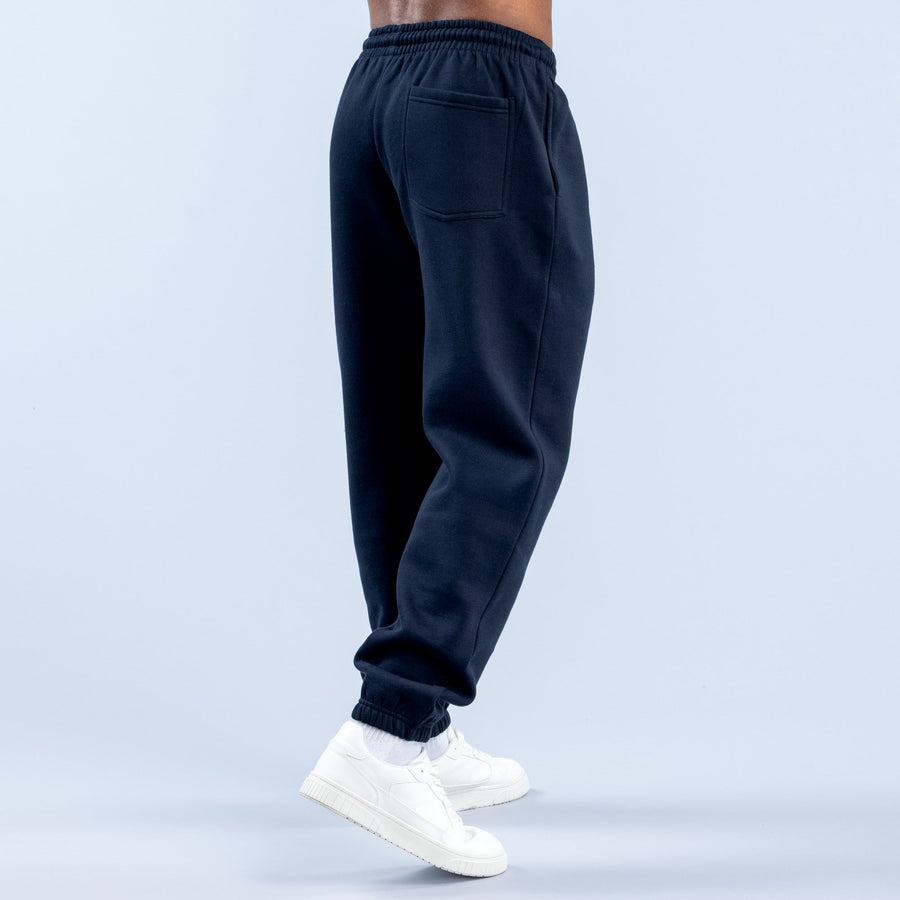 Dark navy joggers with elastic waistband and cuffed tapered ankle hems