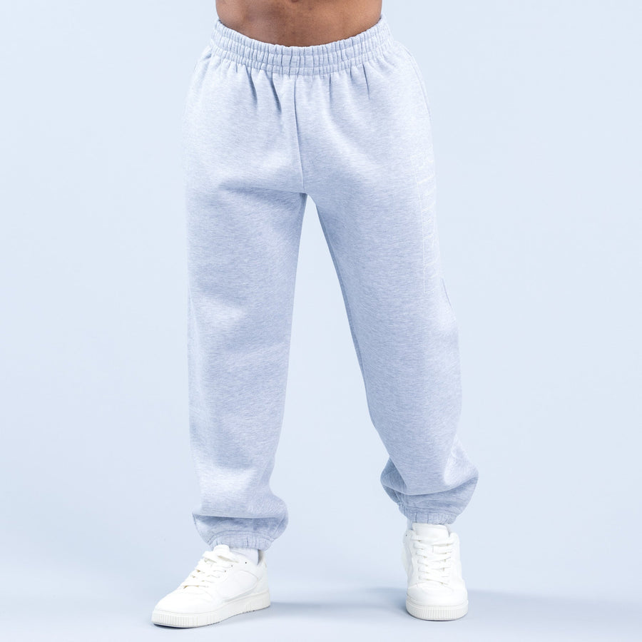 Light blue graphic joggers with elastic waistband and ribbed cuffs, worn with white sneakers