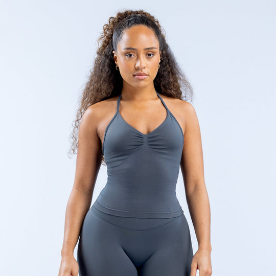 Dark gray longline strappy sports top with V neckline and ruched bust