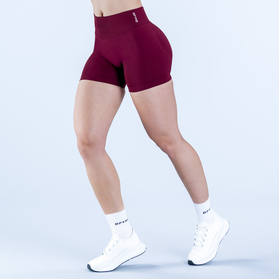 Burgundy 4.5-inch impact shorts, fitted mid-thigh style with elastic waistband