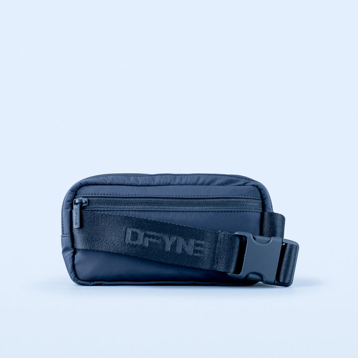 Navy crossbody bag showing front zipper and DPYNE logo patch with side D-ring strap
