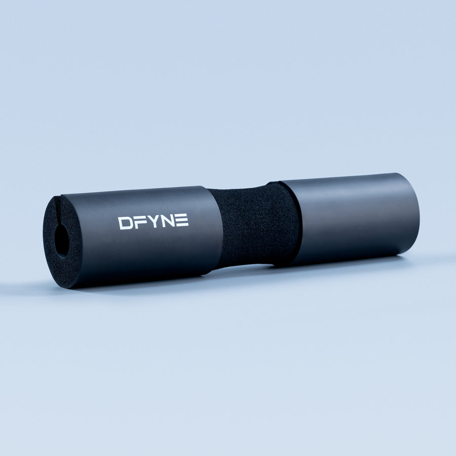 Black barbell pad with DFYNE logo, foam core and cylindrical sleeve