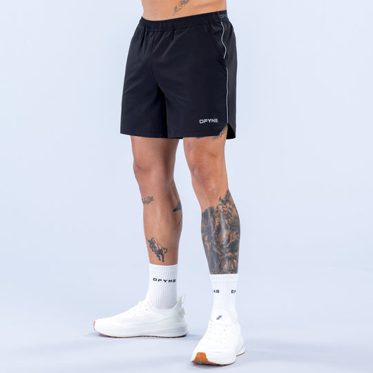 6-inch black training shorts with elastic waistband and side logo accents