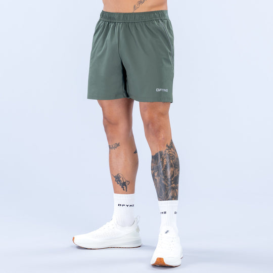 Dark green 6-inch training shorts with elastic waistband and small side logo.