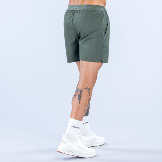 Dark green 6-inch training shorts, back view with elastic waistband and logo detail.