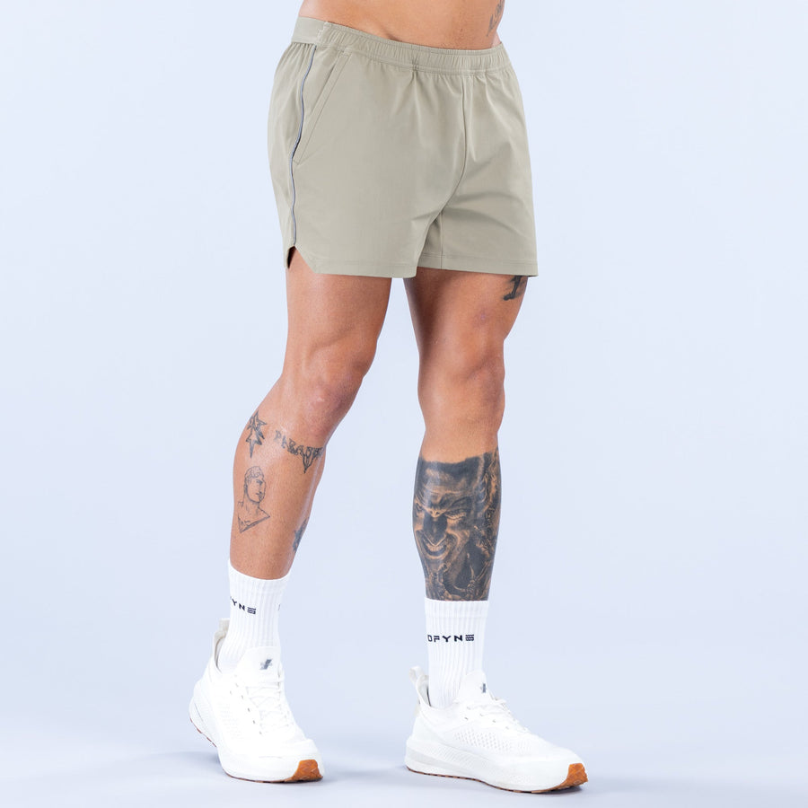 Olive 4-inch training shorts front view with elastic waistband and subtle logo