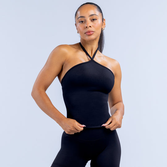 Black longline halter top with crisscross neck straps and fitted stretch knit