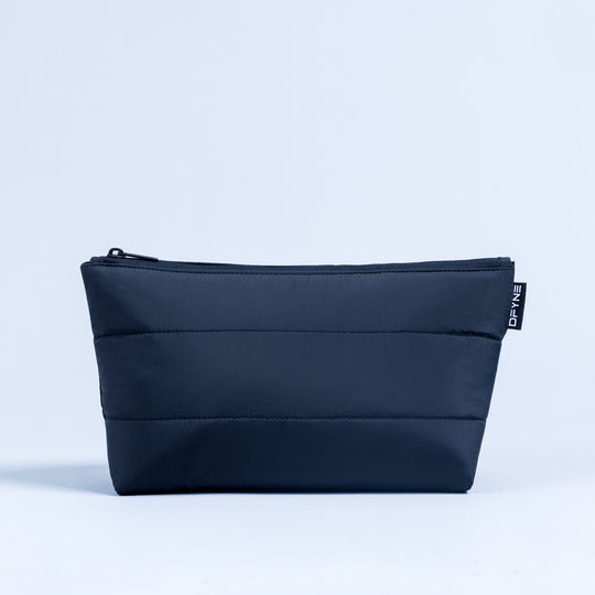 Dark navy rectangular zip pouch with front horizontal quilting and logo label tab
