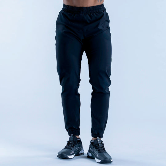 Dark training jogger pants front view with elastic waistband and ankle cuffs