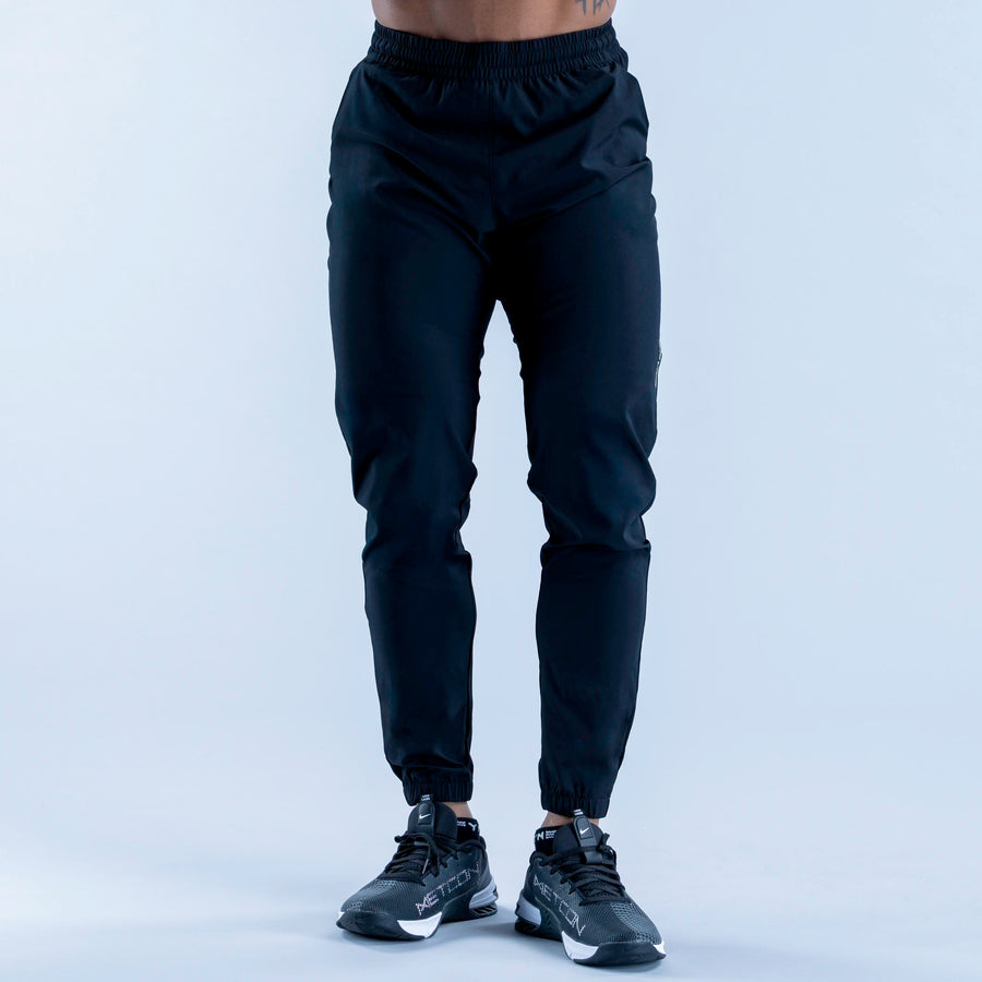 Dark training jogger pants front view with elastic waistband and ankle cuffs
