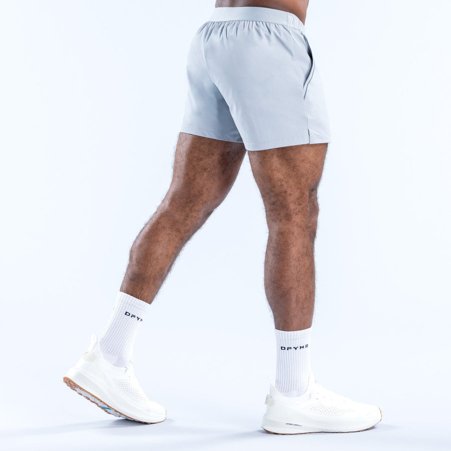 Men's light blue training shorts, 4-in inseam, rear view, elastic waistband