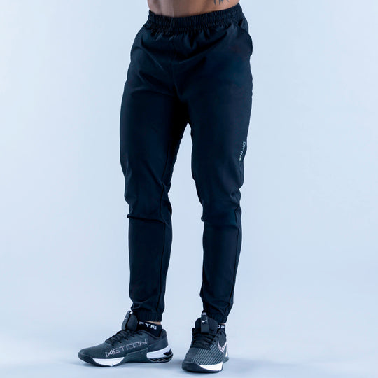 Dark training jogger pants with elastic waistband and tapered legs, ankle cuffs