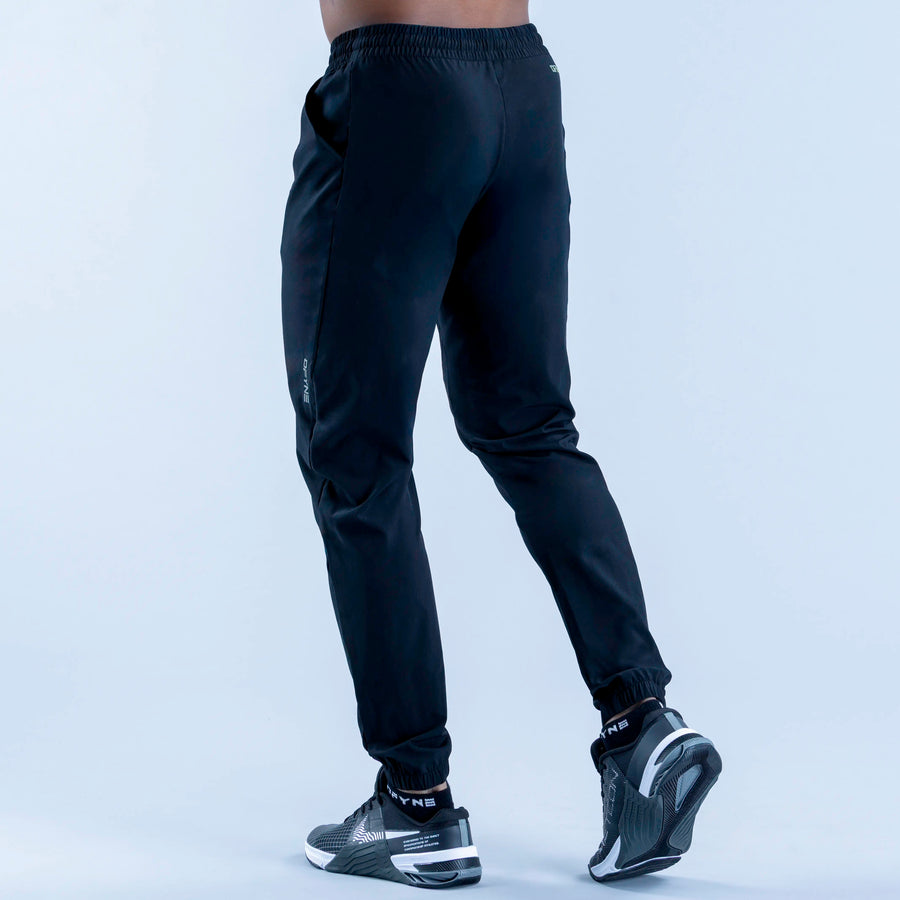 Dark training jogger pants from side view, elastic waistband and tapered fit