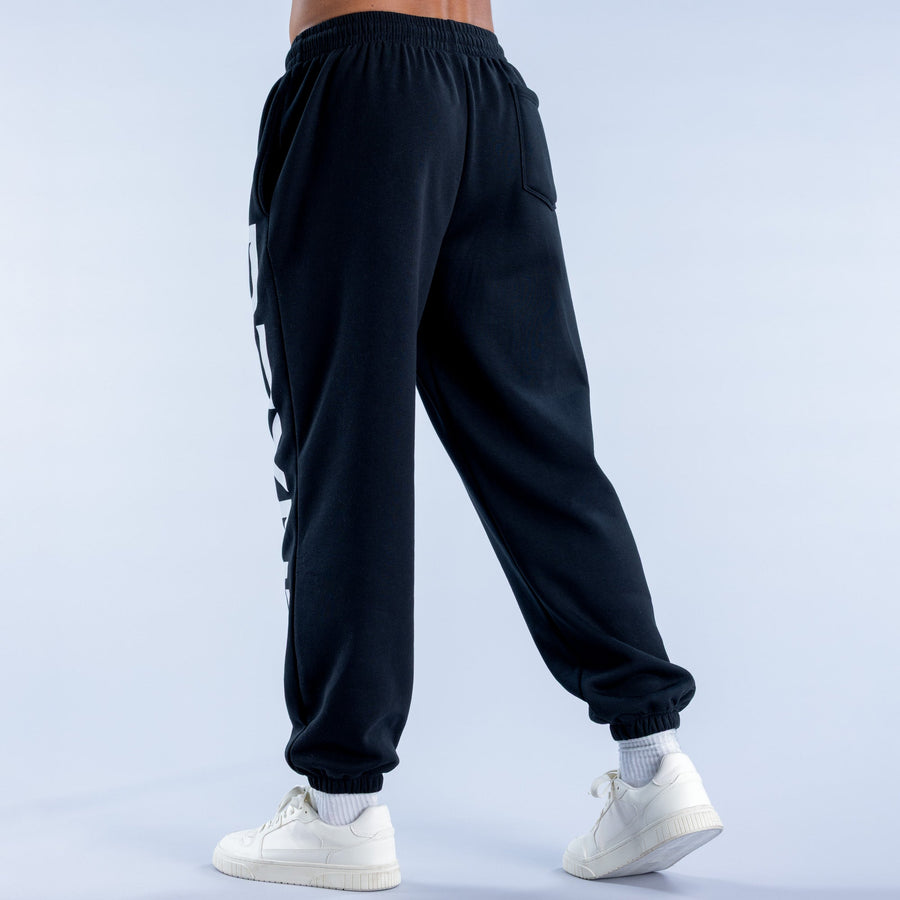 Dark cuffed jogger pants with elastic waist, side pockets, and ankle cuffs