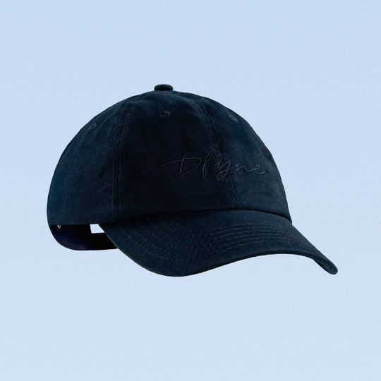 Dark navy script baseball cap with embroidered cursive logo on front