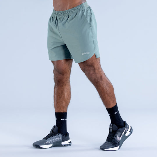 Teal training shorts with elastic waistband and small DPYNE logo on front hem