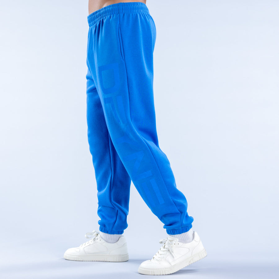 Blue cuffed jogger pants with elastic waistband and leg logo detail