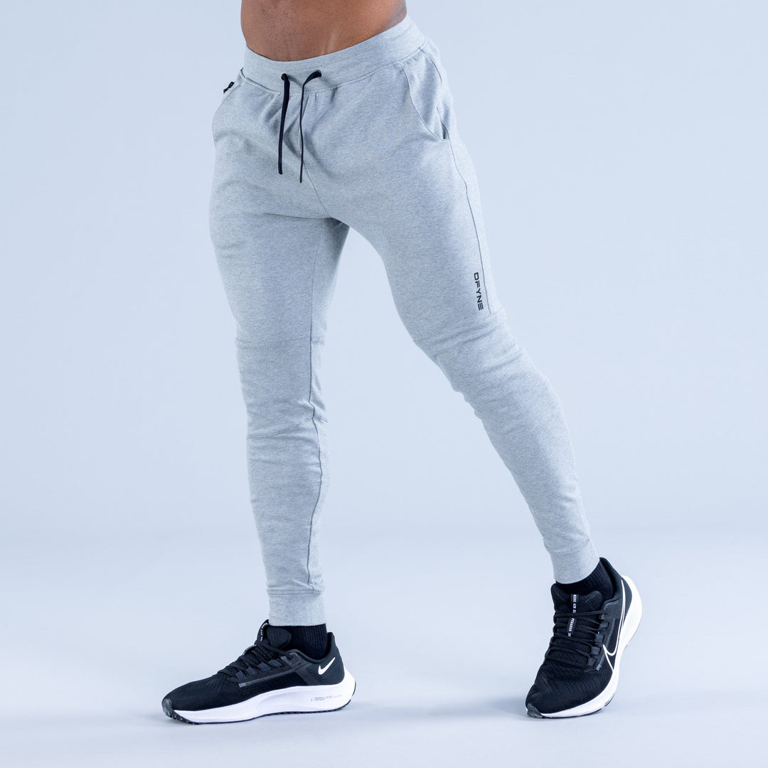 Light gray tapered jogger pants with drawstring waist and side pockets