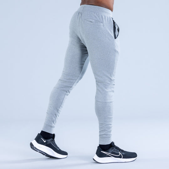 Light gray jogger pants, back view, with drawstring and tapered ankle cuffs