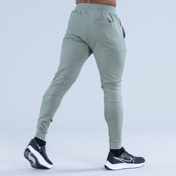 Sage green tapered jogger pants, back view with back pocket and drawstring waistband