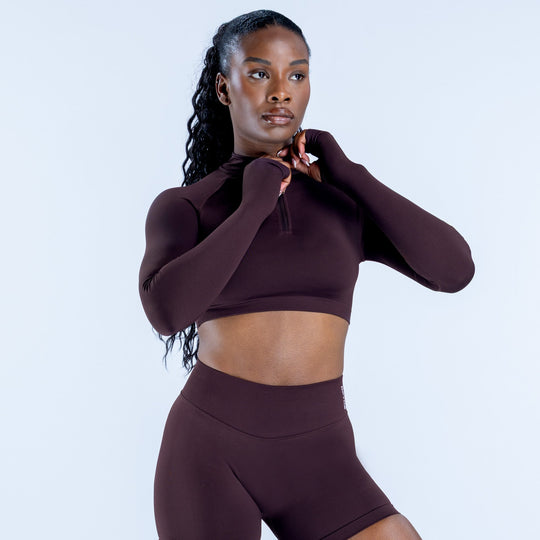 Maroon quarter-zip fitted crop athletic top with long sleeves and mock neck