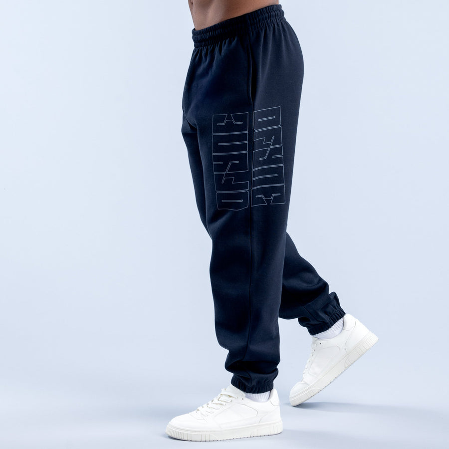 Dark navy graphic joggers with repeating logo-style print on outer thigh