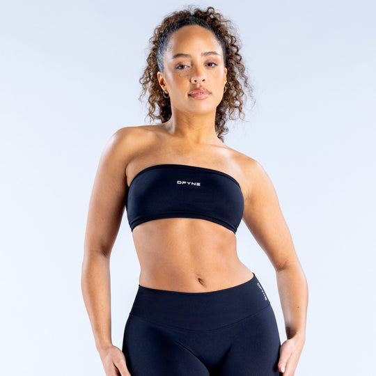 Black backless bandeau sports bra with wide elastic hem and logo on front