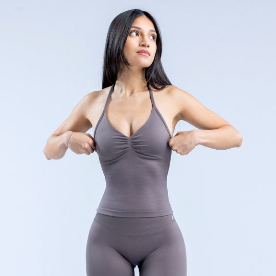 Dark gray longline strappy sports top with racerback straps and gathered bust