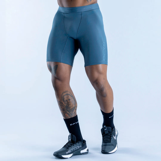 Unbound baselayer shorts in teal, form-fitting with waistband and leg seams