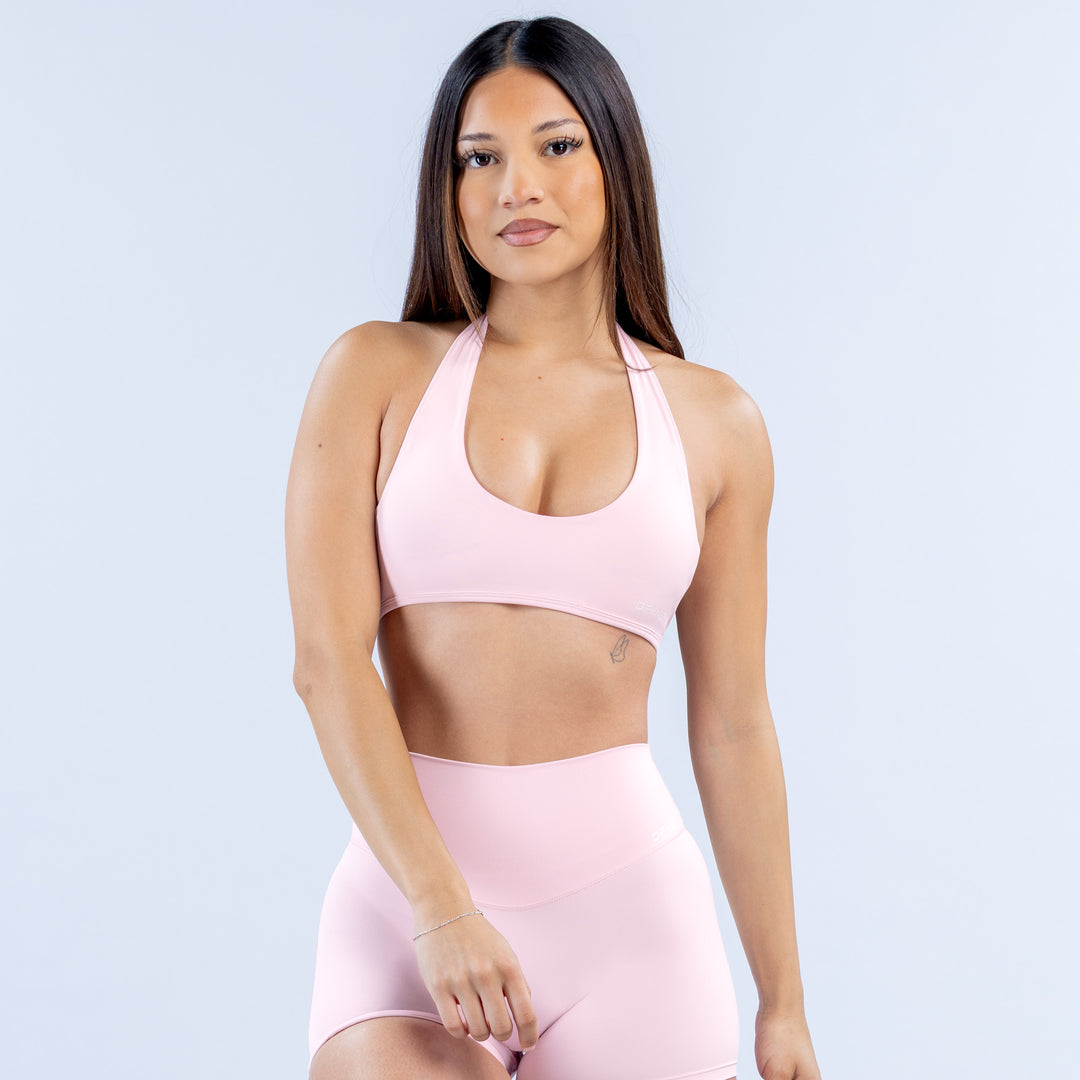 Pink halter bra with scoop front neckline and open-back design
