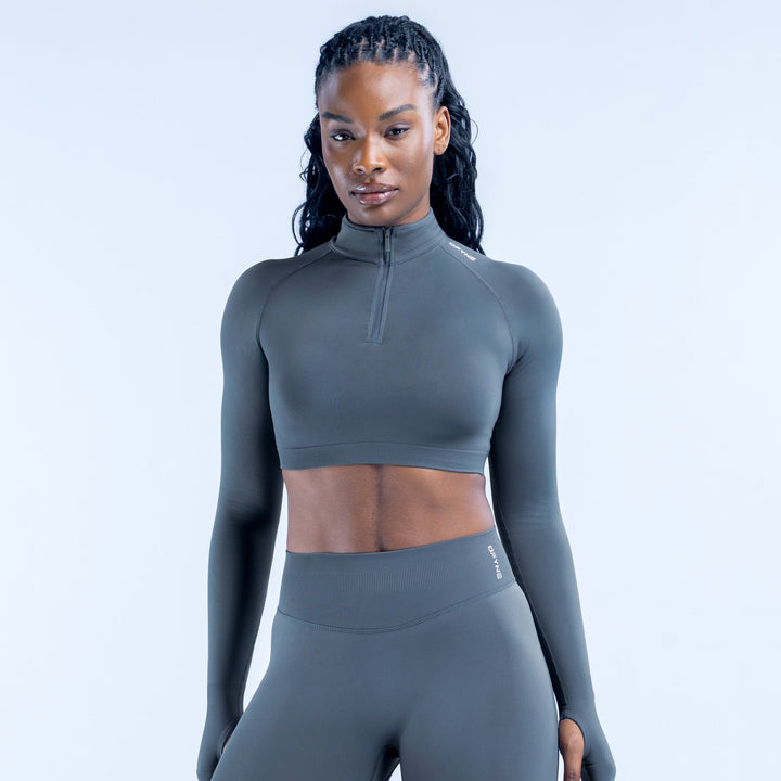 Dark gray cropped long-sleeve athletic top with quarter-zip and high collar