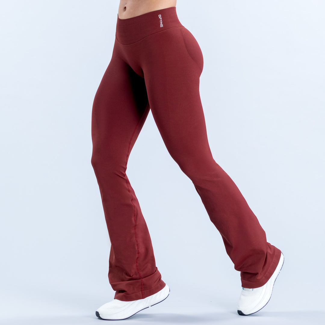 Burgundy flared leggings with a high waistband, shown from the front
