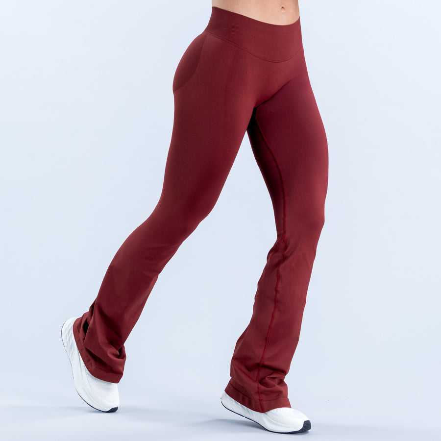 Burgundy flared leggings with a smooth front and fitted upper legs