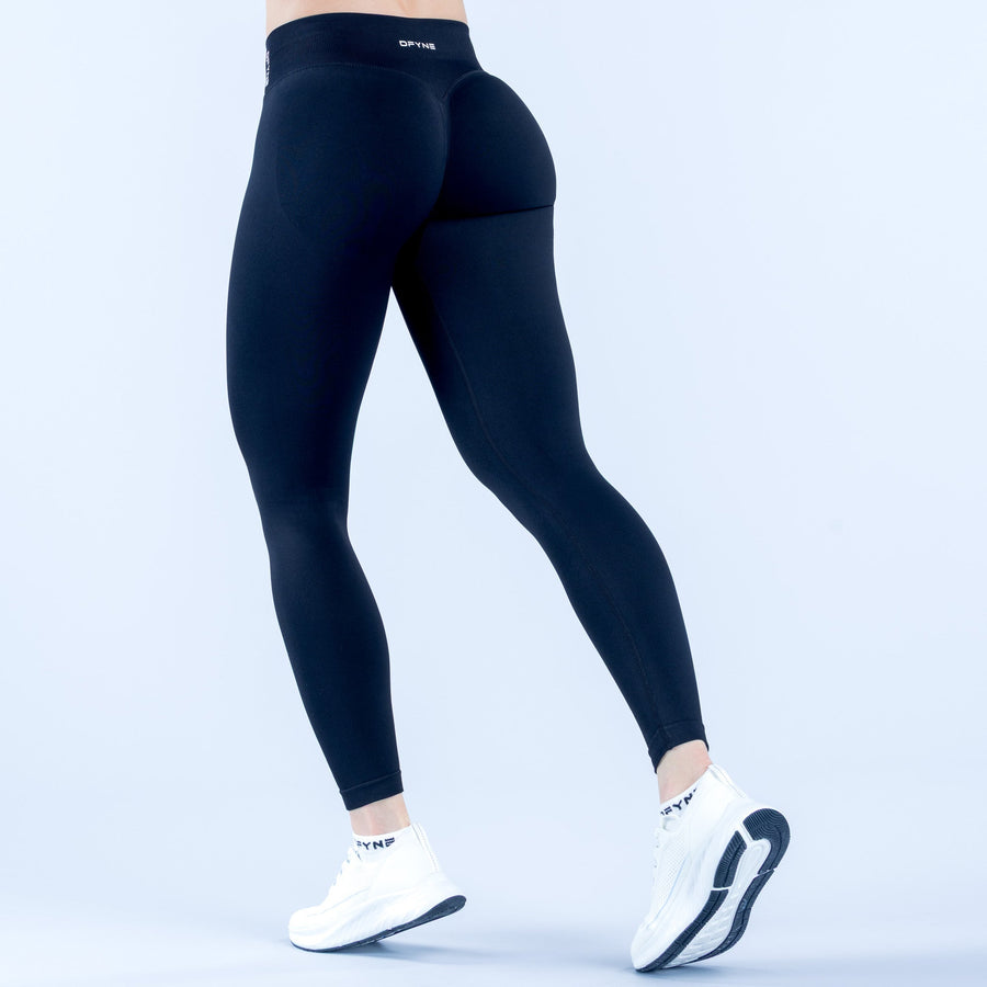 Black high-waist leggings, side view with ankle-length fit and visible logo band