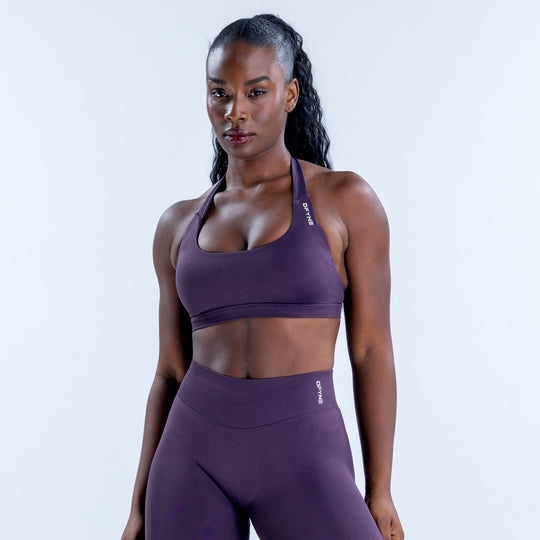 Purple impact sports bra with a scoop neckline and slim shoulder straps, shown from the front.