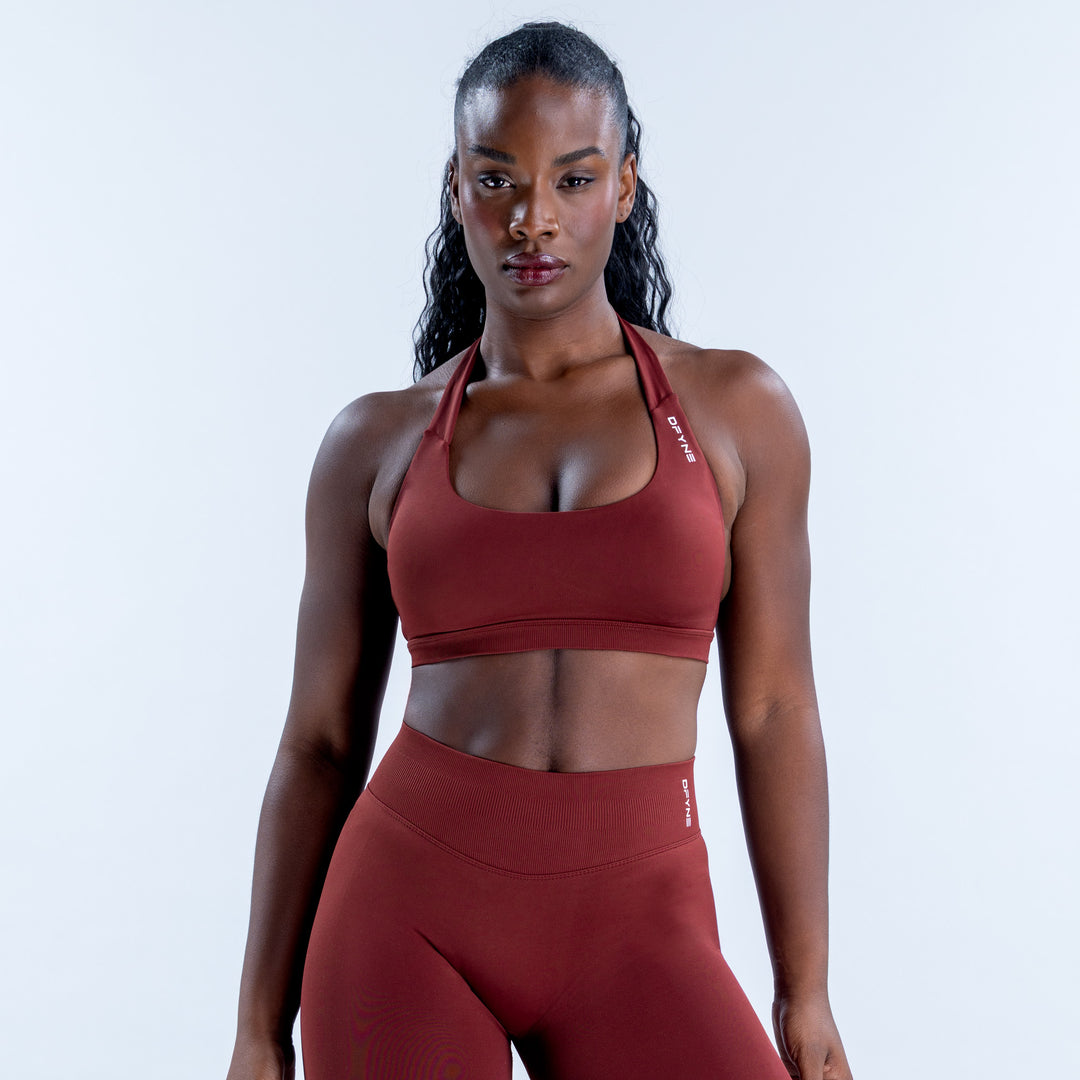 Red Impact Sports Bra with a scoop neckline and halter straps