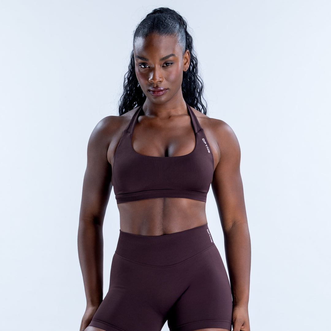 Impact sports bra in deep brown with a scoop neckline and halter straps, front view