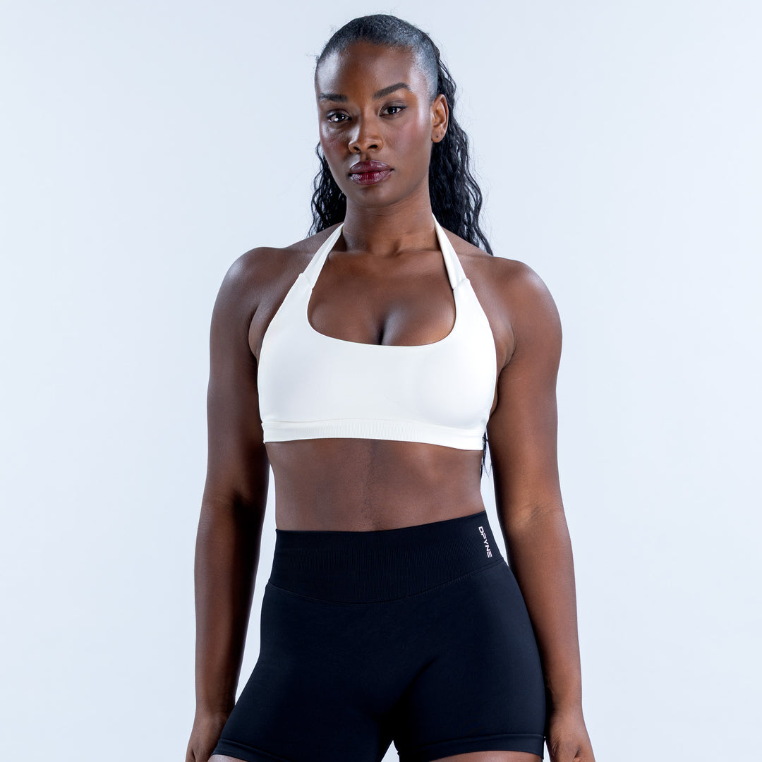 White Impact Sports Bra with a scoop neckline and wide halter straps, front view