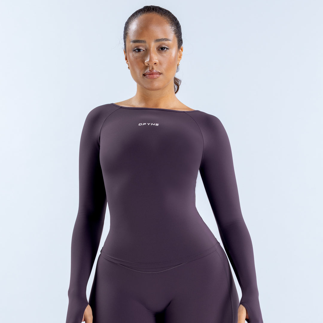 Origin long sleeve scoop neck top in dark plum, front view with fitted silhouette