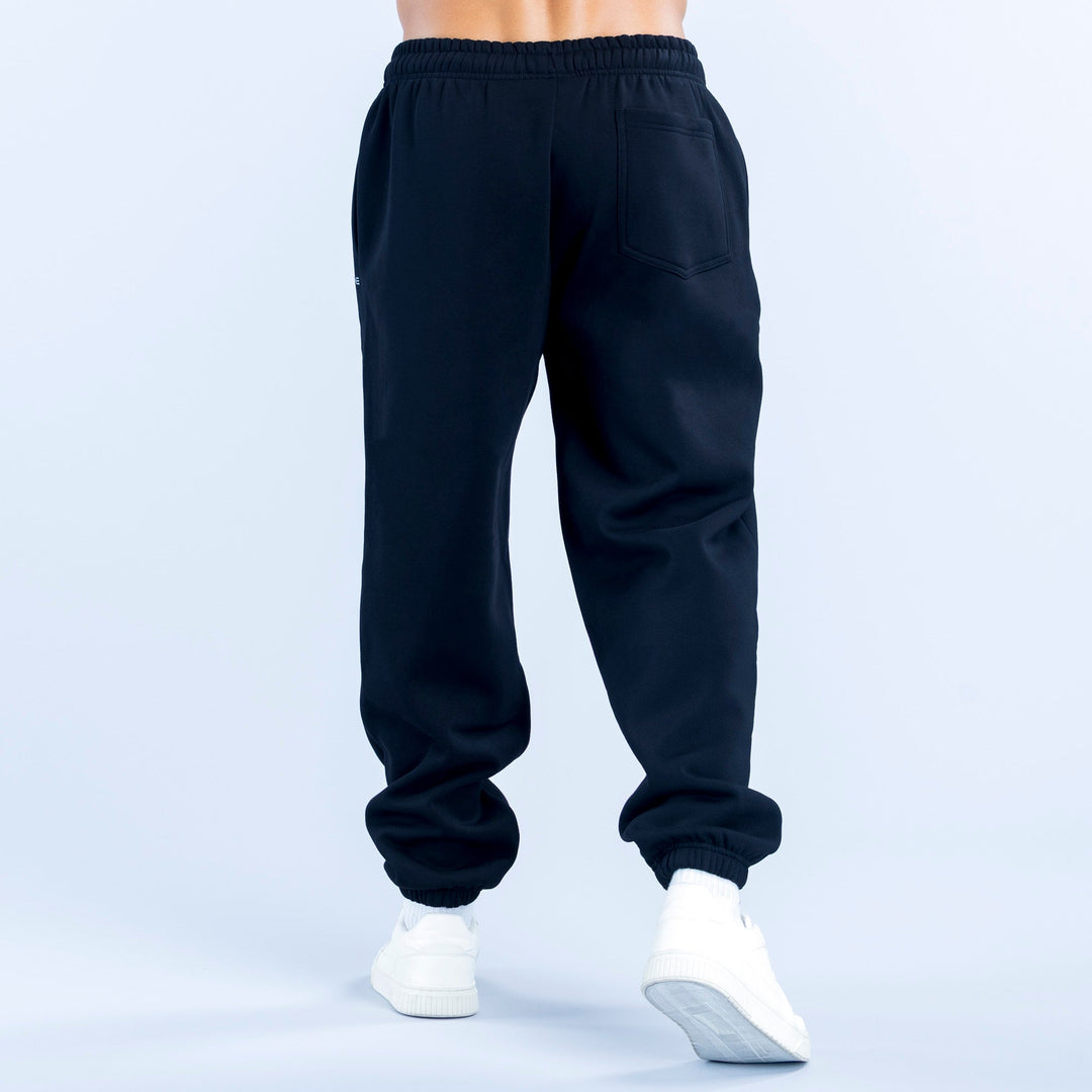 Dark navy joggers with elastic waist, cuffed hems, and a back pocket detail.