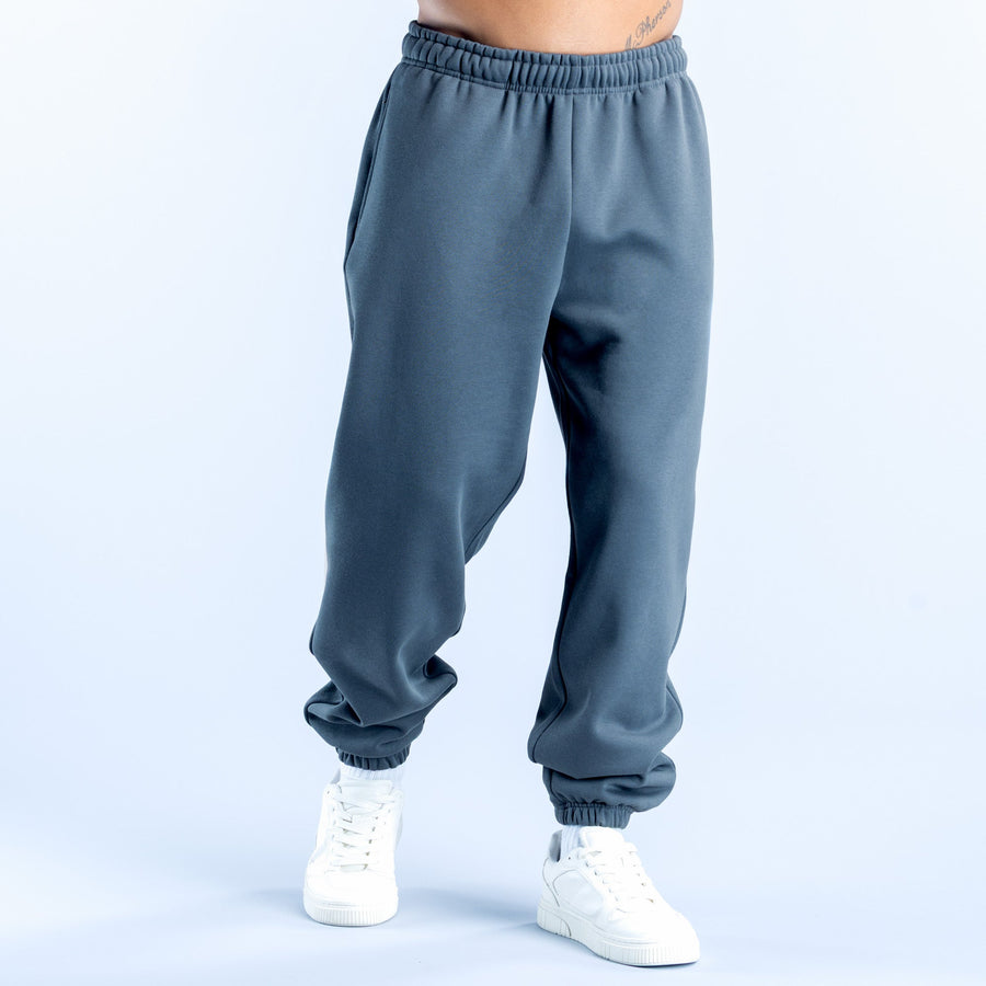 Dark blue joggers with tapered legs and elastic cuffs, front view
