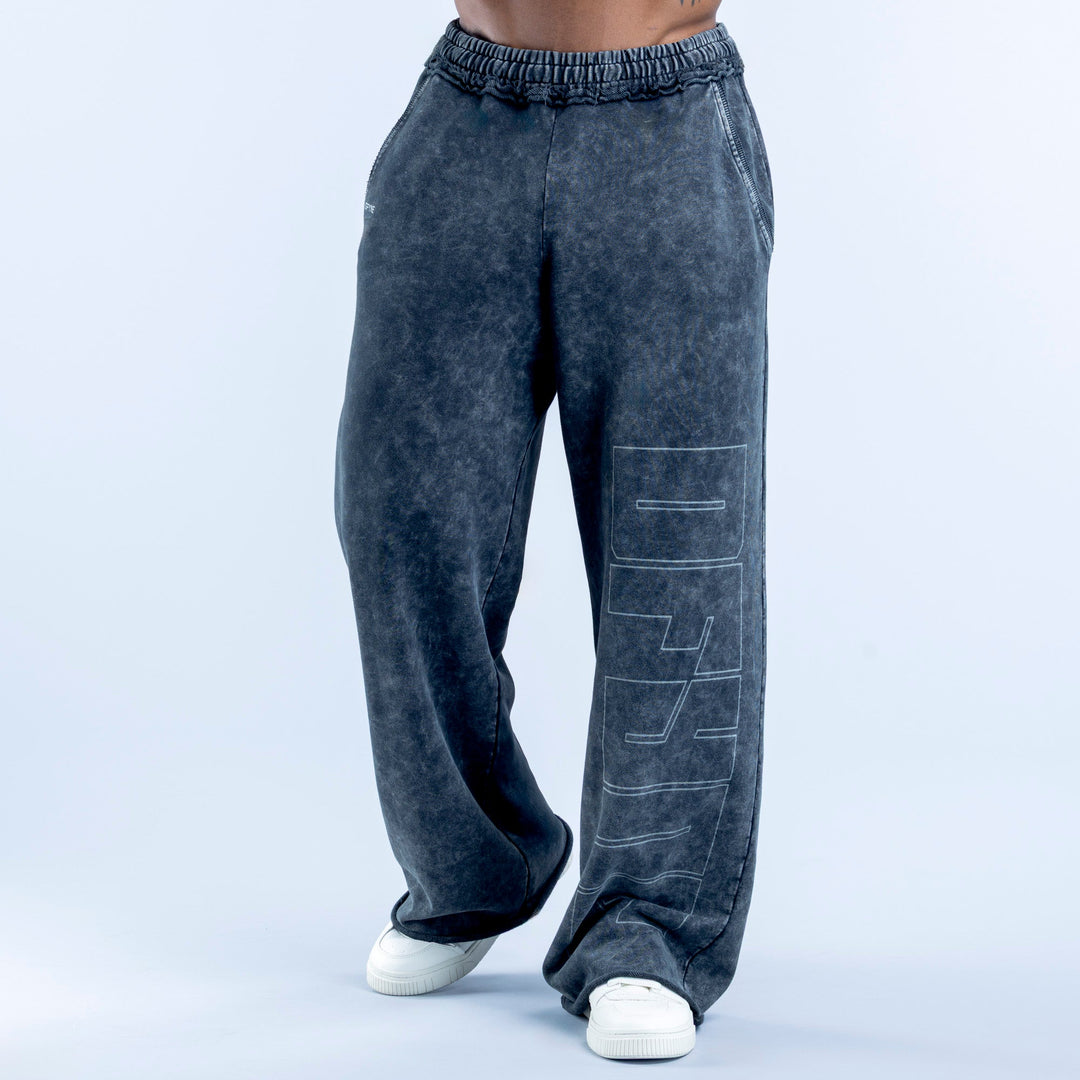 Washed jogger pants in dark navy with elastic waistband and graphic side print