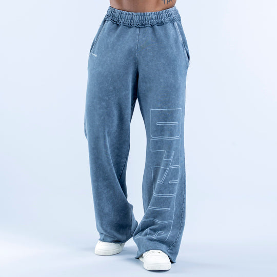Washed jogger pants in blue wash with elastic waistband, side pockets, vertical graphic