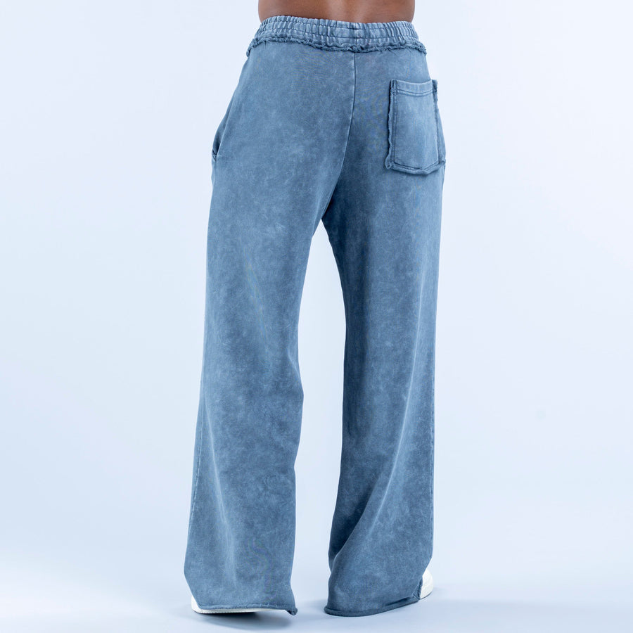 Washed jogger pants in blue wash with elastic waistband, side pockets, relaxed wide legs