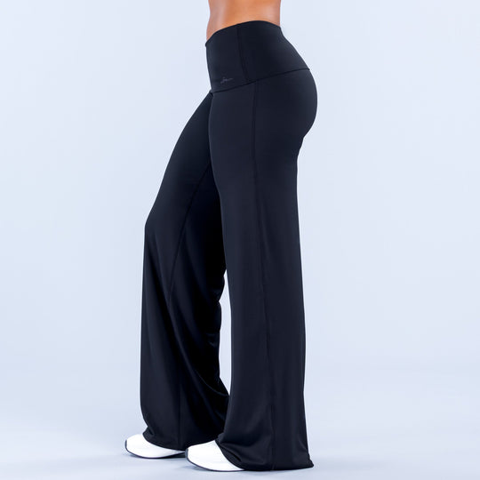 Black fold-over wide-leg pants in rear view with smooth high waist