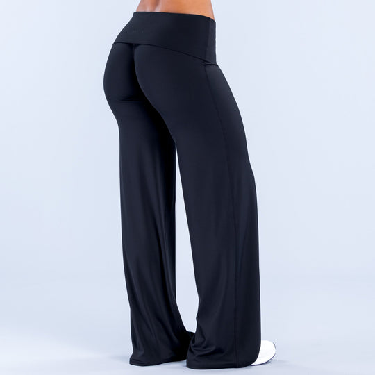 Black fold-over wide-leg pants shown from the side, flowing wide legs