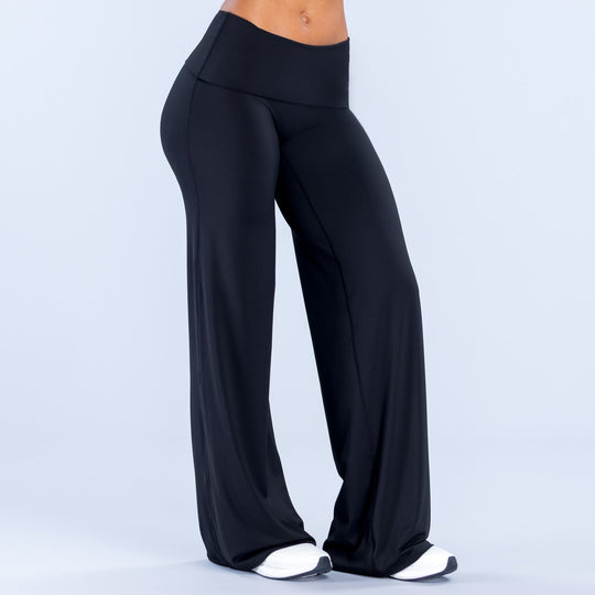 Black fold-over wide-leg pants with wide, draped legs and high waist