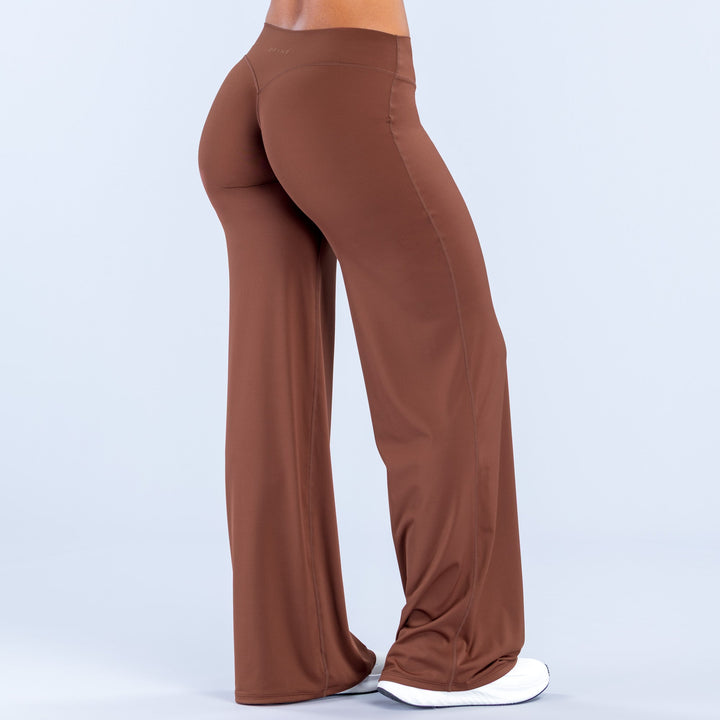 Brown wide-leg pants, back view, elastic waistband and full-length flared legs