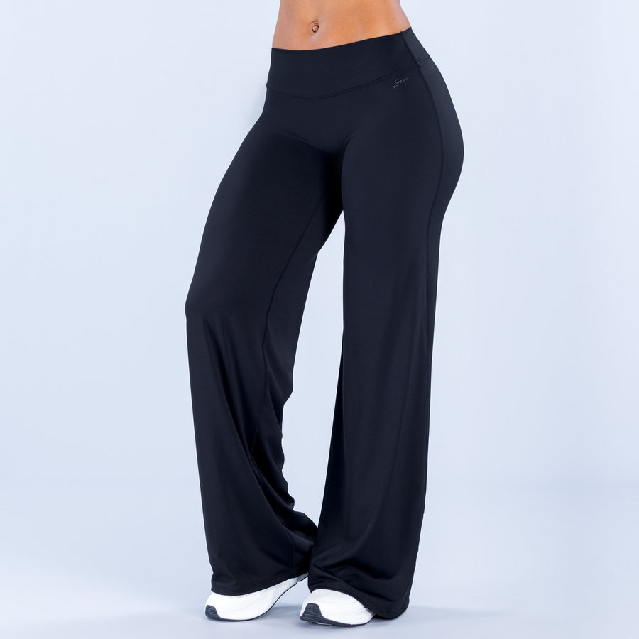 Wide-leg pants, dark black, high-rise fitted waistband, flowing wide legs.