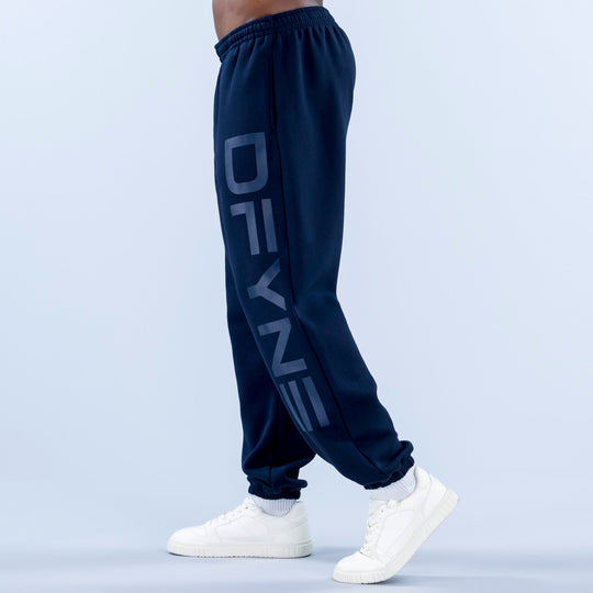 Navy cuffed jogger pants with elastic waistband, side graphic print, and cuffed ankles